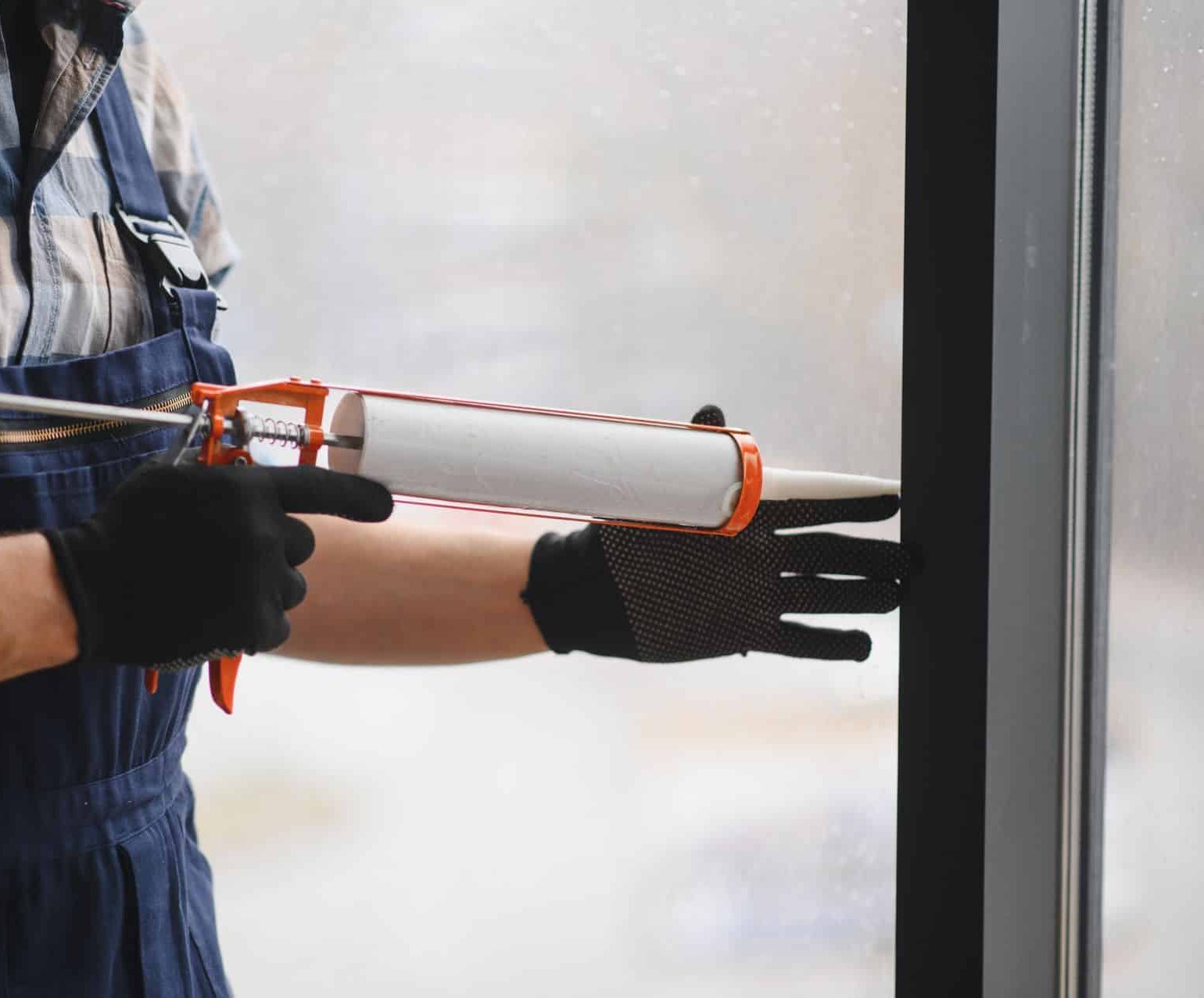construction-worker-applying-sealant-to-window-fra-2026-01-09-11-35-03-utc